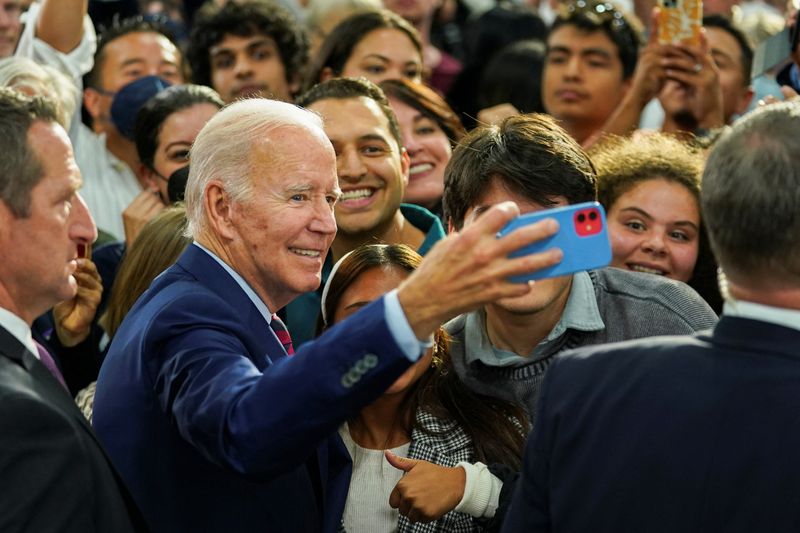 &copy; Reuters. U.S. President Joe Biden takes a selfie with supporters as he participates in a campaign fundraising event for U.S. Rep. Mike Levin (D-CA) in San Diego, California, U.S., November 3, 2022. REUTERS/Kevin Lamarque