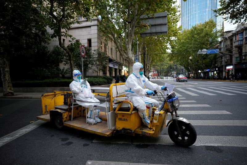 &copy; Reuters. Des travailleurs médicaux en combinaison de protection conduisent un tricycle électrique dans une rue, suite à l'épidémie de coronavirus COVID-19 à Shanghai, en Chine. /Photo prise le 3 novembre 2022/REUTERS/Aly Song