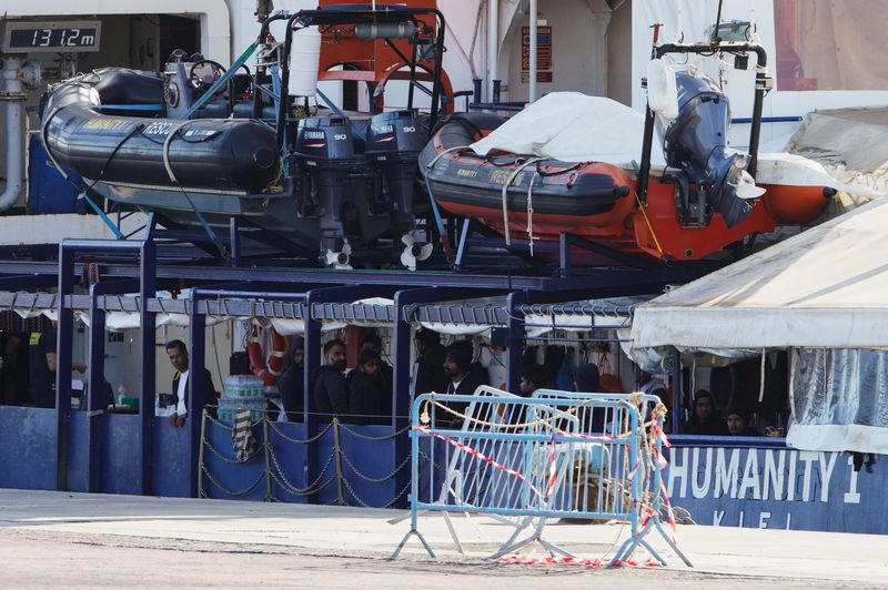 &copy; Reuters. People remaining on the NGO rescue ship "Humanity 1" stand onboard in the port of Catania after Italy allowed the disembarkation of children and sick people in Catania, Italy, November 7, 2022. REUTERS/Antonio Parrinello