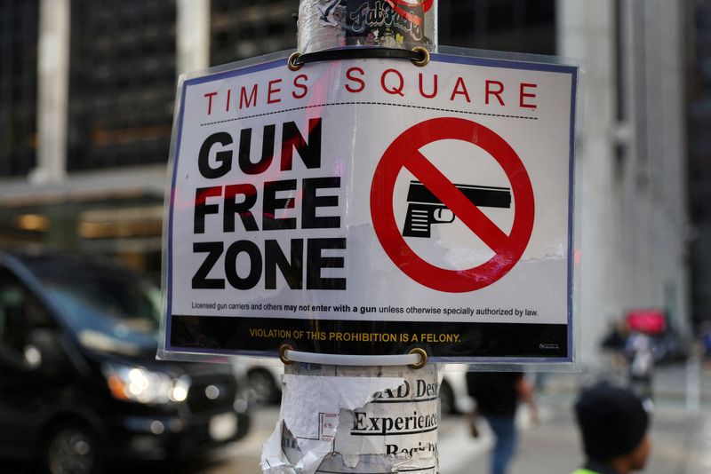 © Reuters. FILE PHOTO: A Times Square Gun Free Zone sign hangs from a light pole on 6th avenue in New York City, U.S., October 10, 2022. REUTERS/Shannon Stapleton/File Photo