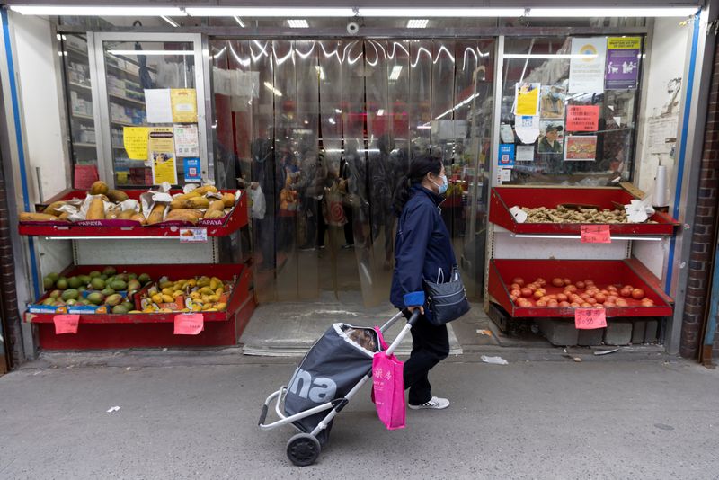 &copy; Reuters. FILE PHOTO: A person walks past a grocery store in Manhattan, New York City, U.S., March 28, 2022. REUTERS/Andrew Kelly