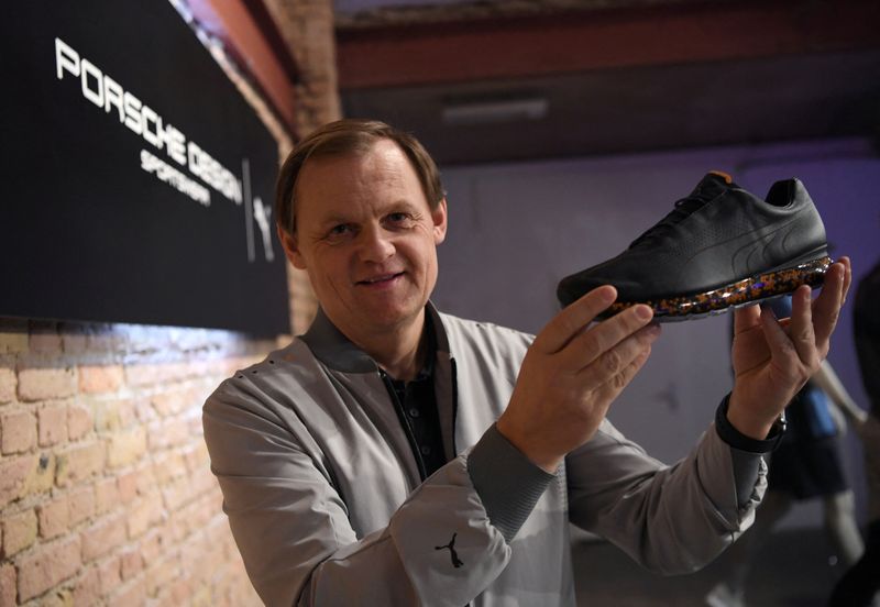 &copy; Reuters. FILE PHOTO: Bjoern Gulden, Chief Executive of Puma, shows a shoe as the sports retailer launches their sportswear collection in collaboration with Porsche Design in Berlin, Germany February 21, 2019. REUTERS/Annegret Hilse
