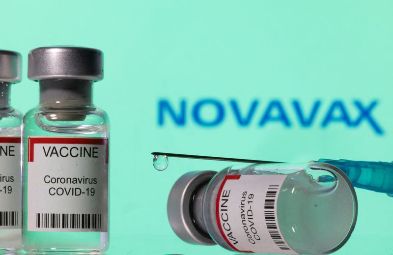 &copy; Reuters. Vials labelled "VACCINE Coronavirus COVID-19" and a syringe are seen in front of a displayed Novavax logo in this illustration taken December 11, 2021. REUTERS/Dado Ruvic/Illustration