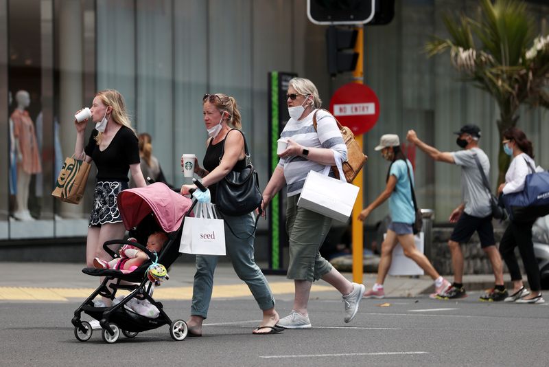 &copy; Reuters. FILE PHOTO: Shoppers walk through a retail district in the wake of coronavirus disease (COVID-19) lockdown restrictions being eased in Auckland, New Zealand, November 10, 2021.  REUTERS/Fiona Goodall/File Photo