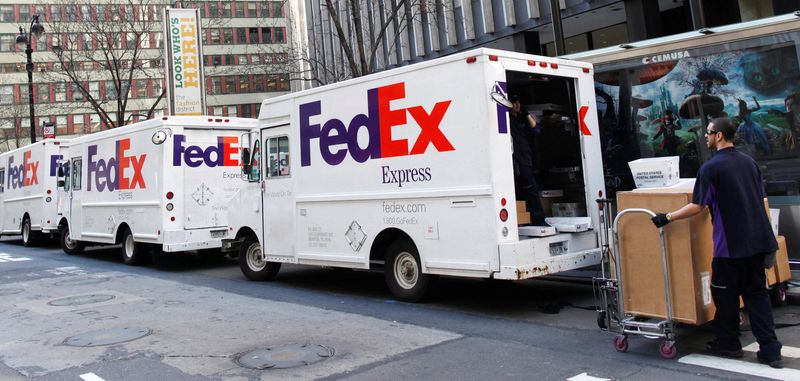 &copy; Reuters. FILE PHOTO: FedEx trucks are seen parked in New York March 18, 2010. Package delivery giant FedEx Corp raised its outlook and posted sharply higher profit, but its shares fell as its domestic volume numbers disappointed investors' hopes for a U.S. economi