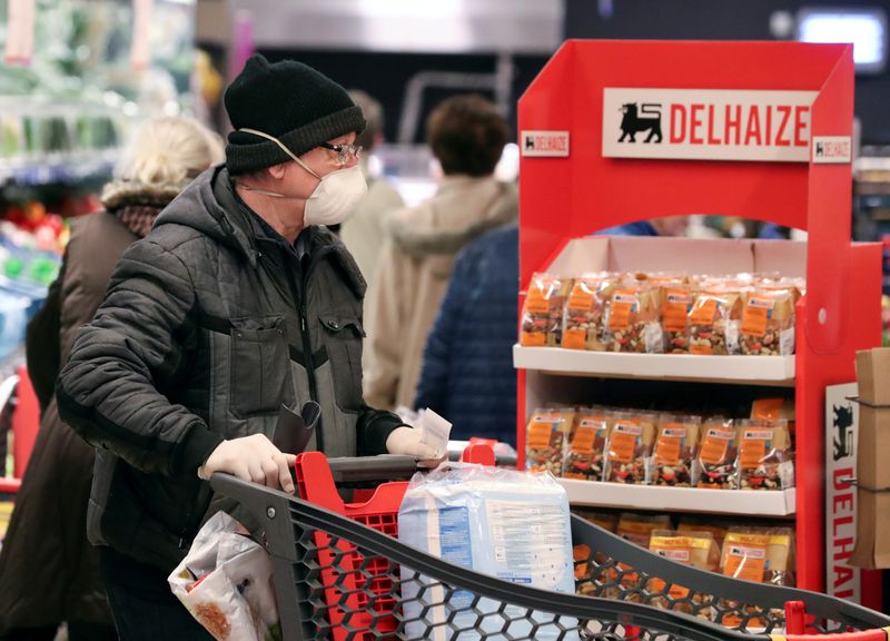 © Reuters. FILE PHOTO: Belgian shoppers are seen inside a Delhaize supermarket as it opens an hour earlier only for people above 65 years old in an attempt to protect the most vulnerable from coronavirus disease (COVID-19) contagion risks, in Brussels, Belgium March 18, 2020.  REUTERS/Yves Herman