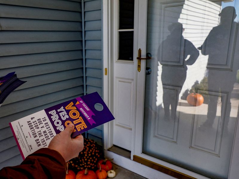 &copy; Reuters. Morgan Koetje and Nickolas Lentz from Reproductive Freedom for All, canvass a neighborhood in support of Proposal 3, a ballot measure that would codify the right to an abortion, one day before the midterm election in Dewitt, Michigan, U.S., November 7, 20