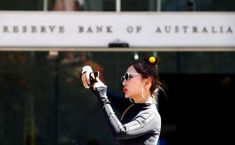 &copy; Reuters. FILE PHOTO: A woman takes a picture next to the Reserve Bank of Australia headquarters in central Sydney, Australia February 6, 2018. REUTERS/Daniel Munoz