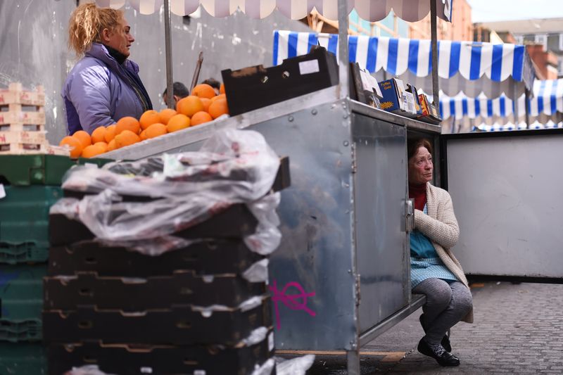 &copy; Reuters. FILE PHOTO: A woman arranges her stall as she chats to her friend at the Moore Street fruit and vegetable market in Dublin, Ireland April 23, 2016. REUTERS/Clodagh Kilcoyne/File Photo