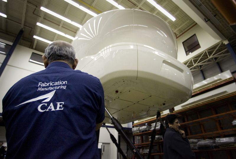&copy; Reuters. FILE PHOTO: An employee looks up at a CAE 7000 Series simulator at the CAE Inc. headquarters in Montreal, March 31, 2009. REUTERS/Christinne Muschi/File Photo