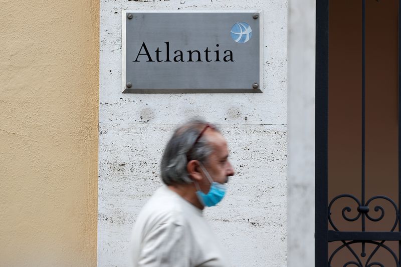 &copy; Reuters. FILE PHOTO: A man walks past the logo of an infrastructure group Atlantia outside their headquarters, in Rome, Italy October 5, 2020. REUTERS/Guglielmo Mangiapane/File Photo