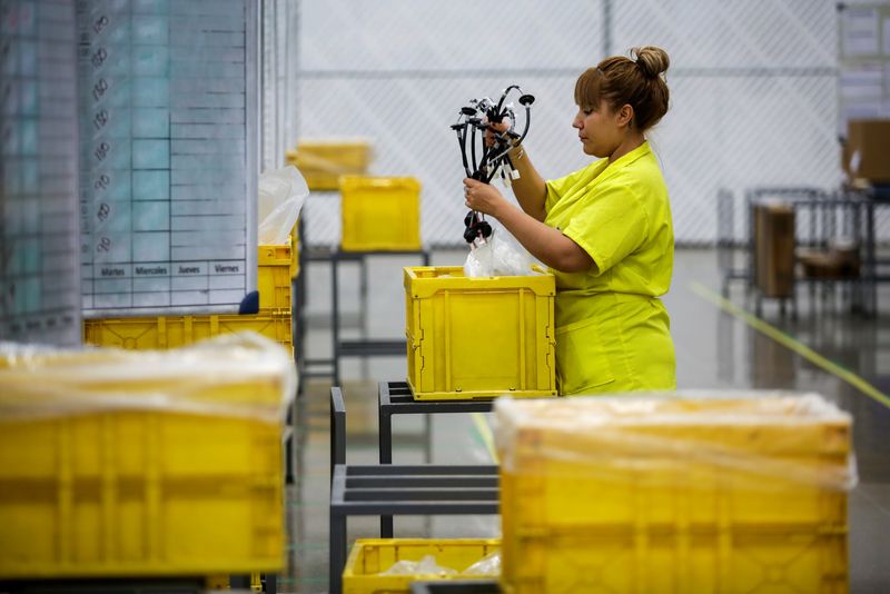&copy; Reuters. FILE PHOTO: An employee works at Ark de Mexico, an assembly factory that makes wire harnesses and electric components for the automobile industry, in Ciudad Juarez, Mexico June 25, 2019. Picture taken June 25, 2019. REUTERS/Jose Luis Gonzalez/File Photo