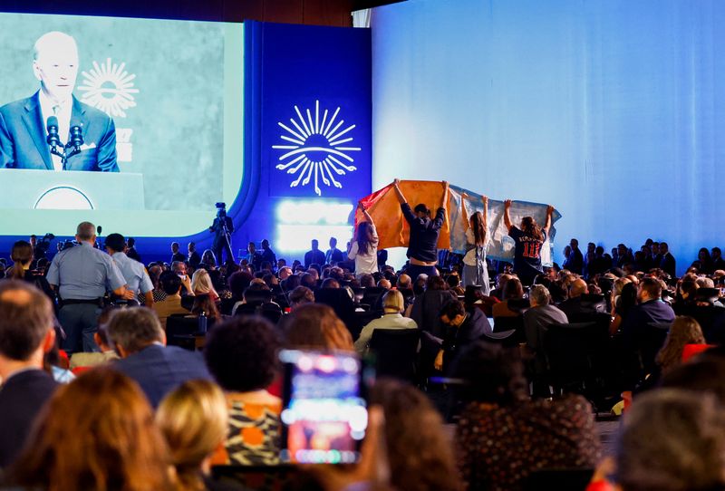 &copy; Reuters. نشطاء للمناخ يحتجون خلال خطاب الرئيس الأمريكي جو بايدن في قمة المناخ بشرم الشيخ يوم الجمعة. تصوير: محمد عبد الغني - رويترز. 
