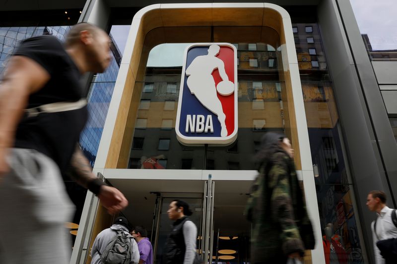 &copy; Reuters. FILE PHOTO: The NBA logo is displayed as people pass by the NBA Store in New York City, U.S., October 7, 2019. REUTERS/Brendan McDermid
