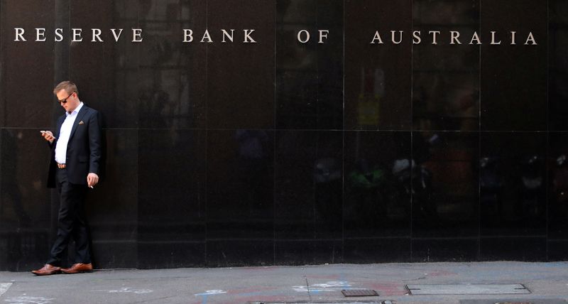 &copy; Reuters. FILE PHOTO: A man smokes next to the Reserve Bank of Australia headquarters in central Sydney, Australia February 6, 2018. REUTERS/Daniel Munoz/File Photo