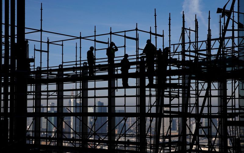 &copy; Reuters. FILE PHOTO: Construction workers are silhouetted while standing on scaffolding at the construction site of the new headquarters of the European Central Bank (ECB) during a guided media tour in Frankfurt, October 31, 2013. REUTERS/Kai Pfaffenbach/File phot
