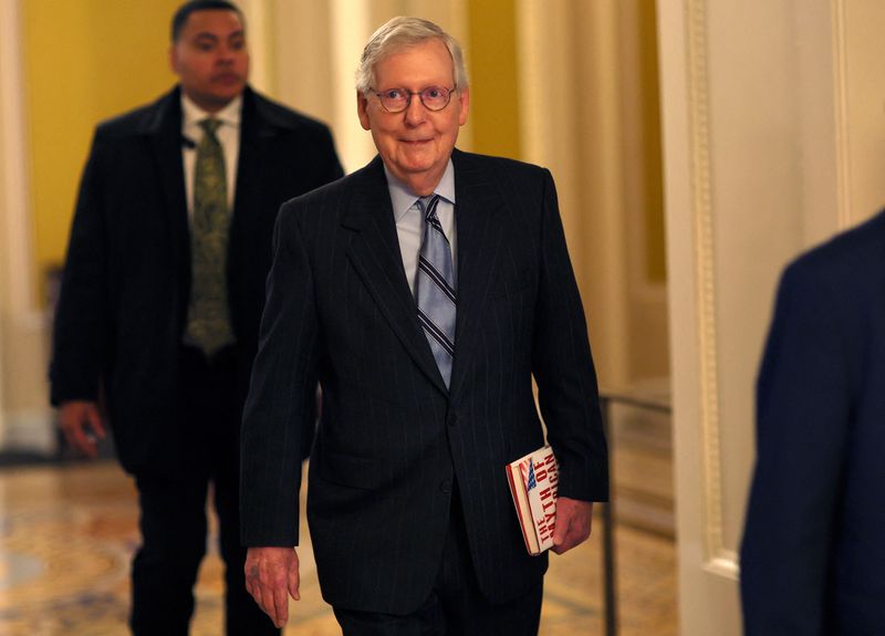 &copy; Reuters. U.S. Senate Republican leader Mitch McConnell carries a book titled “The Myth of American Inequality” as he walks to his office at the U.S. Capitol building in Washington, U.S., November 15, 2022. REUTERS/Leah Millis