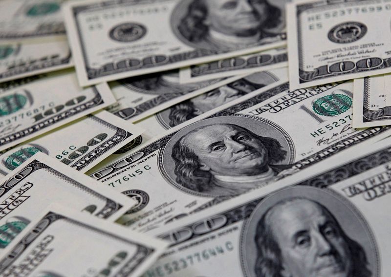 Dollar gains as U.S. spending points to rate hikes; Aussie tumbles