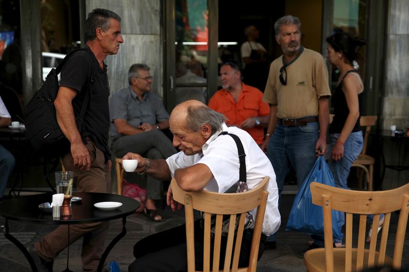 &copy; Reuters. FILE PHOTO: People sit outside a coffee shop in central Athens, Greece, July 20, 2015. REUTERS/Yiannis Kourtoglou