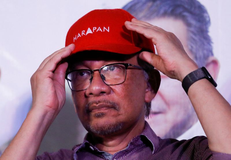 Malaysia's Anwar tries to lock in lead in close election race