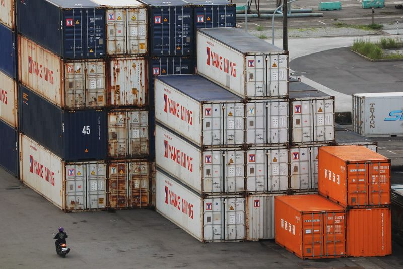 &copy; Reuters. FILE PHOTOP: A person drives a motorcycle by shipping containers at a port in Keelung, Taiwan, June 10, 2020. REUTERS/Ann Wang