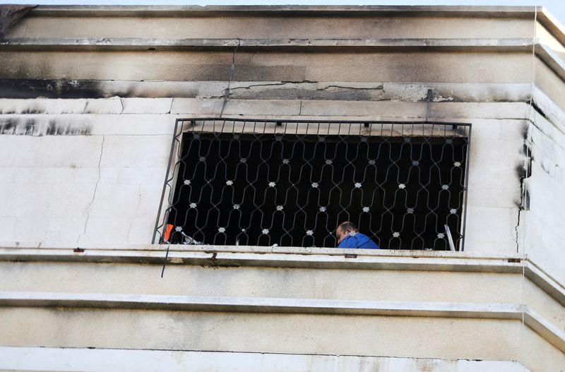 &copy; Reuters. A Palestinian man checks the scene of fire that broke out in a building where residents attended a party in the northern Gaza Strip November 18, 2022. REUTERS/Ibraheem Abu Mustafa