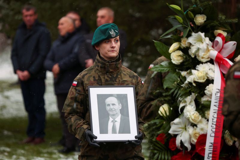 &copy; Reuters. A military member carries a picture of one of two victims of a missile that hit a southeastern Polish village near the border with Ukraine, during his funeral in Przewodow, Poland November 19, 2022. REUTERS/Kacper Pempel