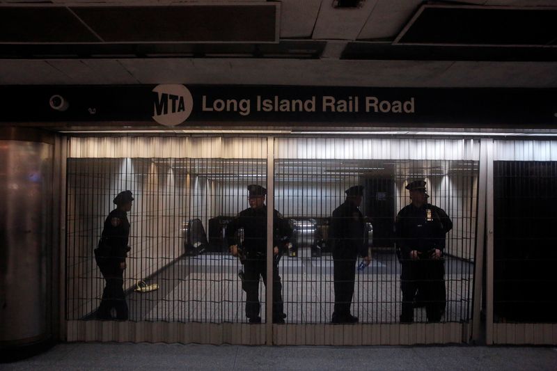 © Reuters. FILE PHOTO: Members of the Metropolitan Transport Authority Police stand behind a closed entrance at Pennsylvania (Penn.) Station in New York City, U.S., March 2, 2018. REUTERS/Andrew Kelly/File Photo