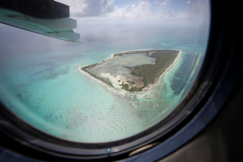 © Reuters. FILE PHOTO: Cay Sal is seen from a window of an HC-144 Ocean Sentry aircraft during a U.S. Coast Guard vessel patrol mission, in the Florida Straits, July 17, 2021. REUTERS/Marco Bello/File Photo
