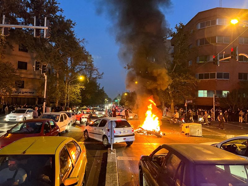 © Reuters. دراجة نارية تابعة للشرطة تحترق خلال احتجاج على وفاة مهسا أميني في طهران يوم 19 سبتمبر أيلول 2022. صورة لرويترز من وكالة أنباء غرب آسيا.