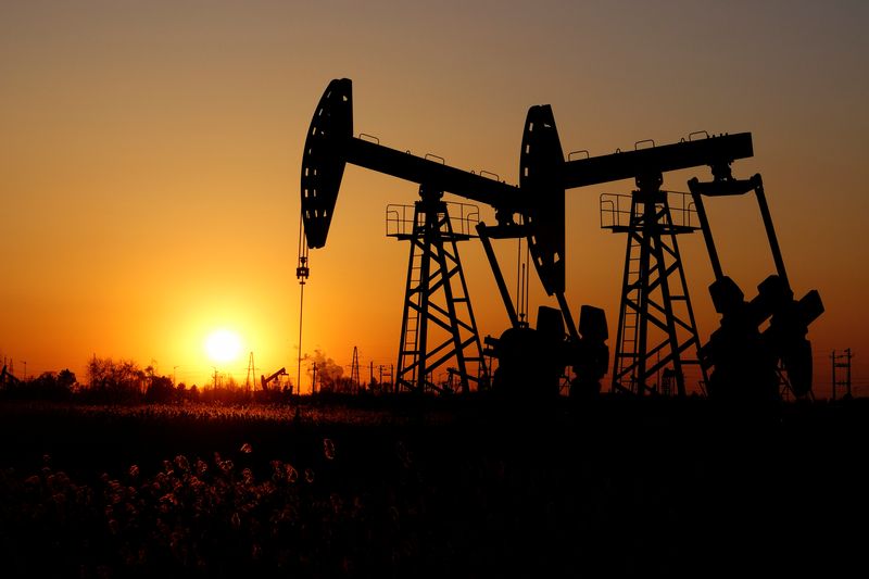 &copy; Reuters. FOTO DE ARCHIVO: Balancines petroleros se ven contra el sol poniente en el campo petrolero de Daqing en la provincia de Heilongjiang