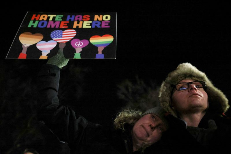 &copy; Reuters. FILE PHOTO: Kendall Allen holds a sign as she attends a vigil with her wife Kaycie Franks after a mass shooting at the Club Q LGBTQ nightclub, in Colorado Springs, Colorado, U.S., November 21, 2022. REUTERS/Kevin Mohatt/File Photo