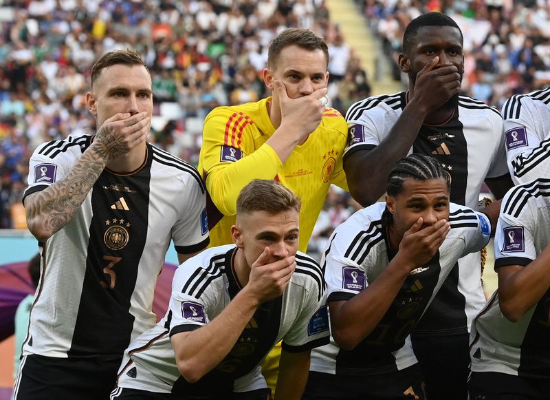 Soccer-Germany players cover mouths in team photo amid armband row