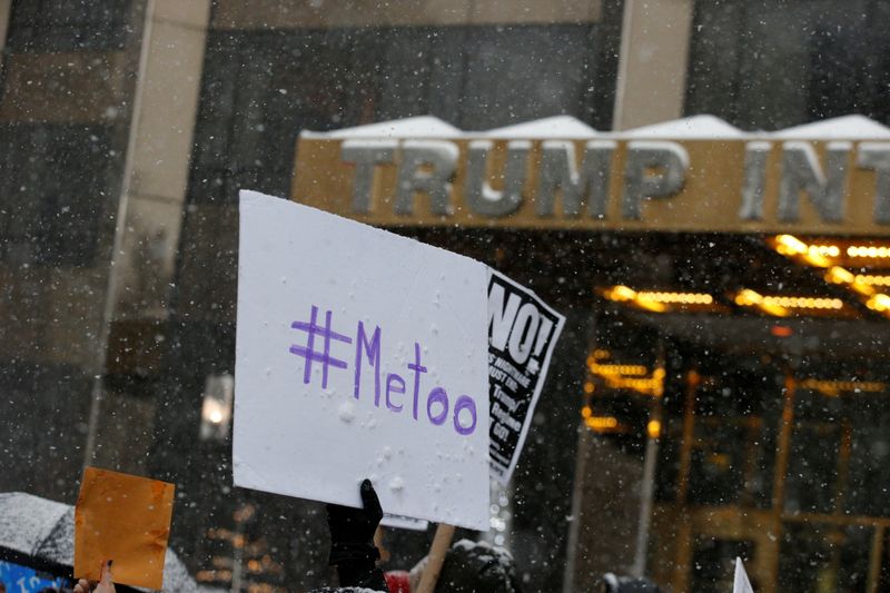 © Reuters. FILE PHOTO: Protest signs are raised at #MeToo demonstration outside Trump International hotel in New York City, NY, U.S., December 9, 2017. REUTERS/Brendan McDermid/File Photo