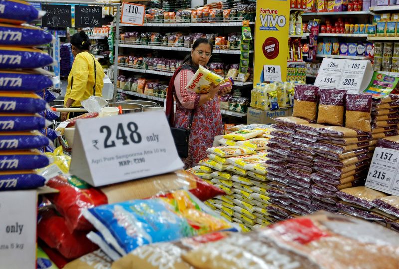 &copy; Reuters. FILE PHOTO: A woman looks at an item as she shops at a food superstore in Ahmedabad, India October 13, 2016. REUTERS/Amit Dave