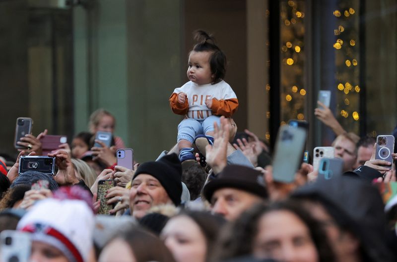 Americans celebrate Thanksgiving with parades, feasts and football
