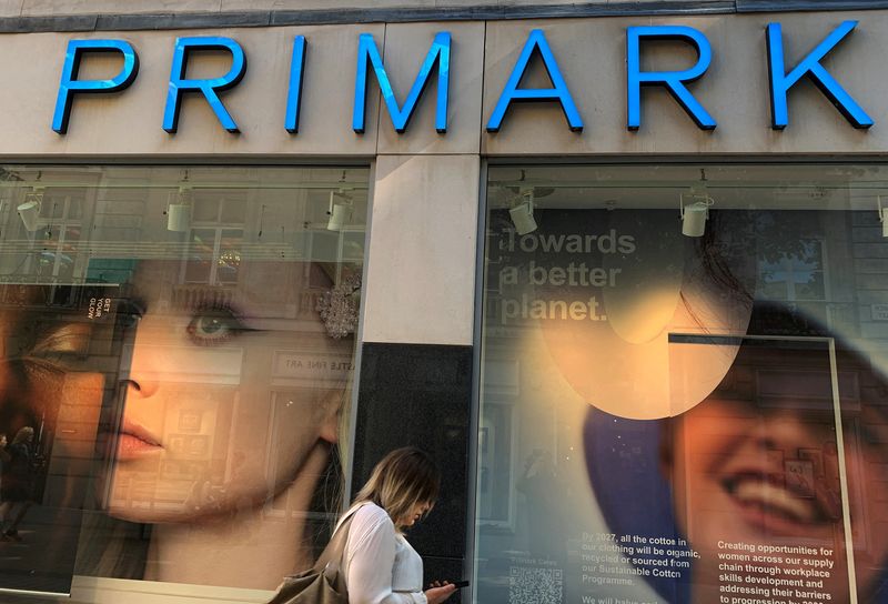 &copy; Reuters. FILE PHOTO: A woman walks past a window display showing new environmentally themed posters at a Primark store in Liverpool, Britain, September 15, 2021. REUTERS/Phil Noble