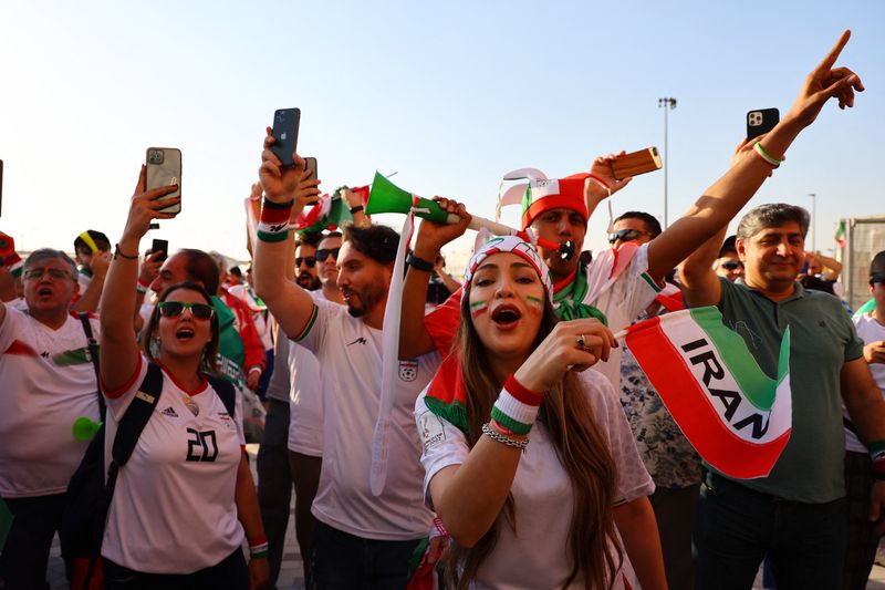 © Reuters. Soccer Football - FIFA World Cup Qatar 2022 - Group B - Wales v Iran - Ahmad Bin Ali Stadium, Al Rayyan, Qatar - November 25, 2022     Iran fans celebrate outside the stadium after the match REUTERS/Fabrizio Bensch