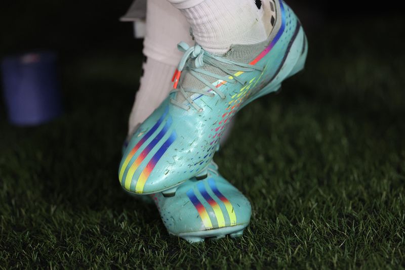 © Reuters. FILE PHOTO: Soccer Football - FIFA World Cup Qatar 2022 - Group B - United States v Wales - Ahmad Bin Ali Stadium, Al Rayyan, Qatar - November 21, 2022 General view of rainbow coloured adidas boots REUTERS/Carl Recine