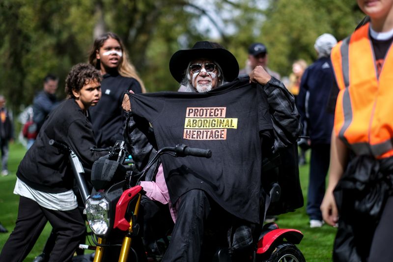 &copy; Reuters. FILE PHOTO: A man displays a t-shirt with a message reading "Protect Aboriginal Heritage" during a protest by aboriginal groups against what they say is a lack of detail and consultation on new heritage protection laws, after the Rio Tinto mining group de