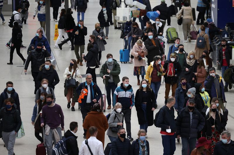 &copy; Reuters. FILE PHOTO: People wearing protective face masks walk through Waterloo train station, amid the coronavirus disease (COVID-19) outbreak, in London, Britain, January 3, 2022. REUTERS/Henry Nicholls