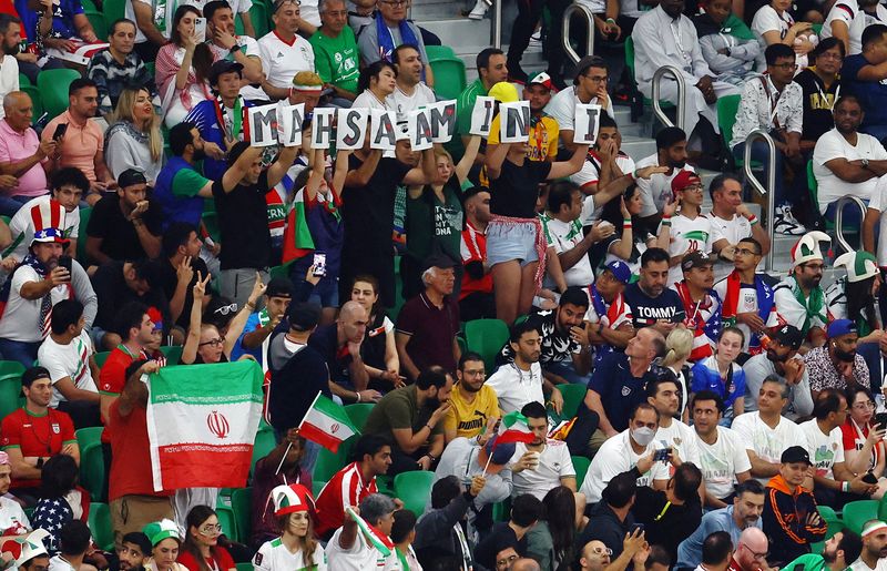 © Reuters. Soccer Football - FIFA World Cup Qatar 2022 - Group B - Iran v United States - Al Thumama Stadium, Doha, Qatar - November 29, 2022 Iran fans display the name of Mahsa Amini in the stands during the match REUTERS/Molly Darlington