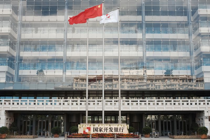 &copy; Reuters. FILE PHOTO: A Chinese flag (C) flutters at the headquarters of China Development Bank (CDB) in Beijing, China September 23, 2018. Picture taken September 23, 2018.  REUTERS/Florence Lo