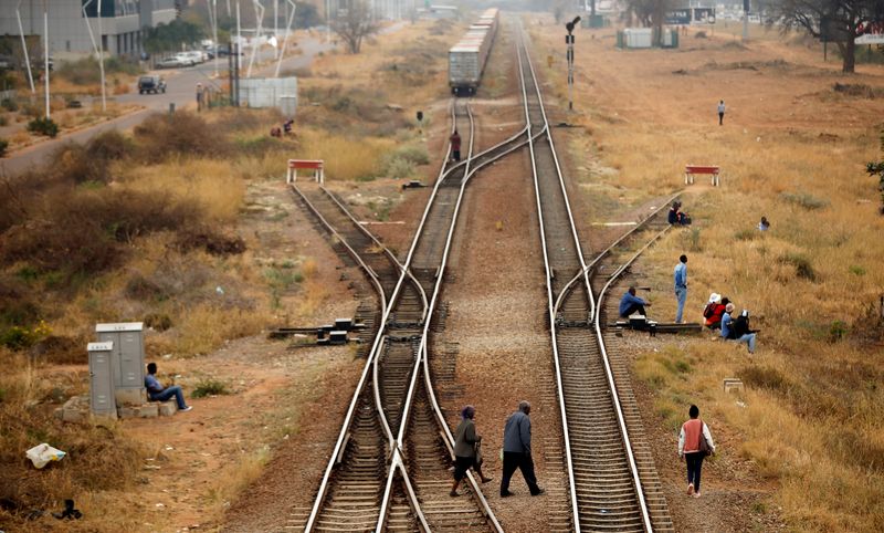 &copy; Reuters. FILE PHOTO: People cross rail tracks in the Central Business District (CBD), in the capital Gaborone, Botswana, September 21, 2018. REUTERS/Siphiwe Sibeko