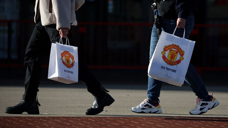 &copy; Reuters. FILE PHOTO: General view as people walk with Manchester United bags outside Old Trafford in Manchester, Britain, November 23, 2022 REUTERS/Phil Noble/