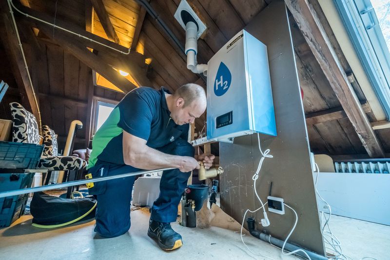 © Reuters. A workman installs a hydrogen boiler in an attic in the Dutch town of Lochem, Netherlands, December 1, 2022. Dennis Mikkelsen/BDR Thermea/Handout via REUTERS