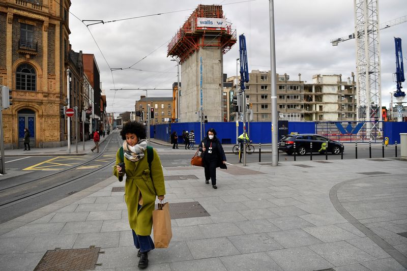 &copy; Reuters. FILE PHOTO: People walk near a demolition site in Dublin, Ireland, February 11, 2022. REUTERS/Clodagh Kilcoyne