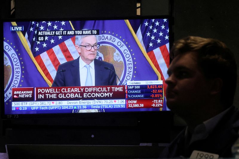 &copy; Reuters. FILE PHOTO: A screen displays Federal Reserve Chair Jerome Powell speaking as a trader works on the floor of the New York Stock Exchange (NYSE) in New York City, U.S., November 2, 2022.  REUTERS/Brendan McDermid/File Photo