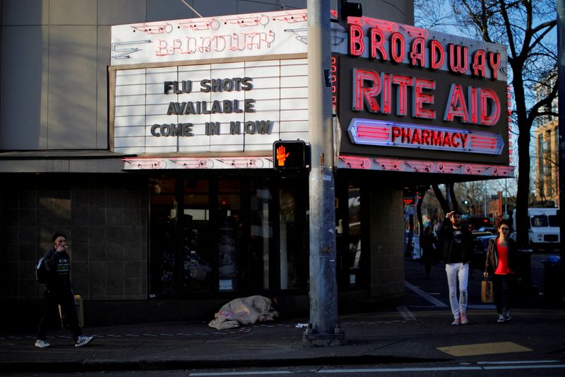 © Reuters. FILE PHOTO: The sign over a drug store advertises flu shots amid the coronavirus (COVID-19) outbreak in Seattle, Washington, U.S., March 17, 2020.   REUTERS/Brian Snyder/File Photo