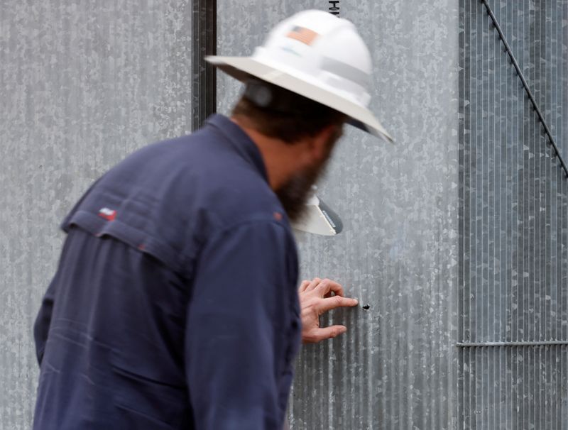 © Reuters. FILE PHOTO: Duke Energy workers inspect what they said was one of three bullet holes that crippled an electrical substation after the Moore County Sheriff said that vandalism caused a mass power outage, in Carthage, North Carolina, U.S. December 4, 2022.  REUTERS/Jonathan Drake